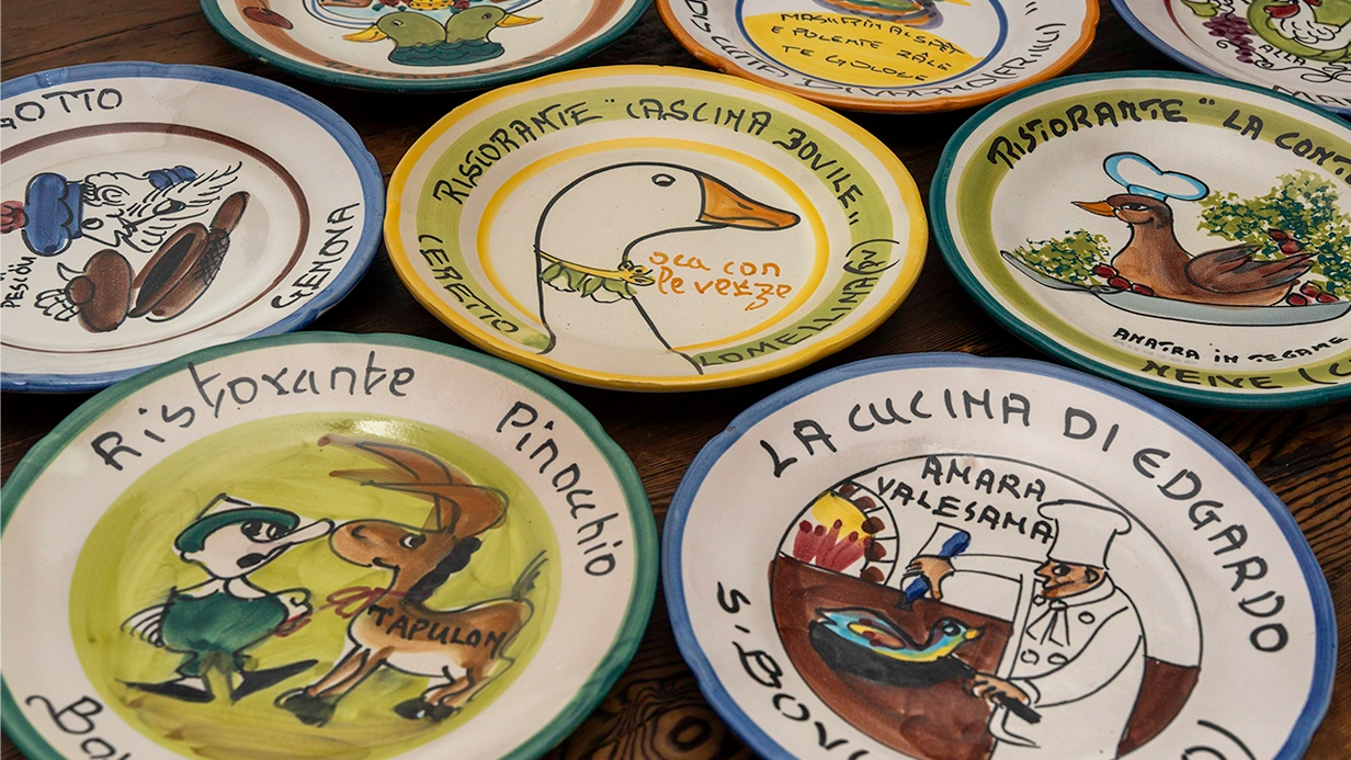 Hand-painted Buon Ricordo antique Italian ceramic plates featuring traditional restaurant designs. Unique vintage tableware collection from Gordina.