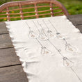 Bild in Galerie-Betrachter laden, Handcrafted embroidered cotton table runner with light bulb pattern, inspired by festive traditions and glowing memories.