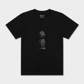 Load image into Gallery viewer, Star and House black T-shirt flat lay showing the embroidered chest motif