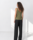 Bild in Galerie-Betrachter laden, The Poppy Olive Green linen tank top with cream poppy embroidery, model back view