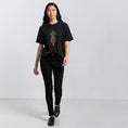 Bild in Galerie-Betrachter laden, The Ward Faded Black women’s T-shirt with cream embroidery, full-length front view