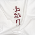 Load image into Gallery viewer, Close-up of the burgundy garden-sign embroidery on the Water and Garden T-shirt