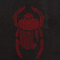 Bild in Galerie-Betrachter laden, Close-up of red scarab embroidery stitched on the black Gordina Scarab T-shirt.