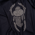 Load image into Gallery viewer, Angled macro detail of ivory scarab embroidery stitched onto navy cotton.