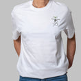 Load image into Gallery viewer, White organic cotton t-shirt with minimalist seated figure and plant embroidery on chest, Gordina