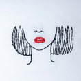 Load image into Gallery viewer, Close-up of white organic cotton t-shirt with minimalist face embroidery and red lips detail, Gordina