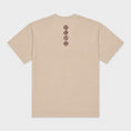 Charger l'image dans la visionneuse de la galerie, Back flat lay of the beige Gordina Unsigned T-shirt with vertical burgundy cross-stitch embroidery.
