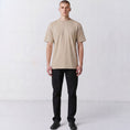 Charger l'image dans la visionneuse de la galerie, Front view of a model wearing the plain-front beige Gordina Unsigned T-shirt.