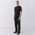 Charger l'image dans la visionneuse de la galerie, Undeciphered embroidered T-shirt in black, small chest motif, front view
