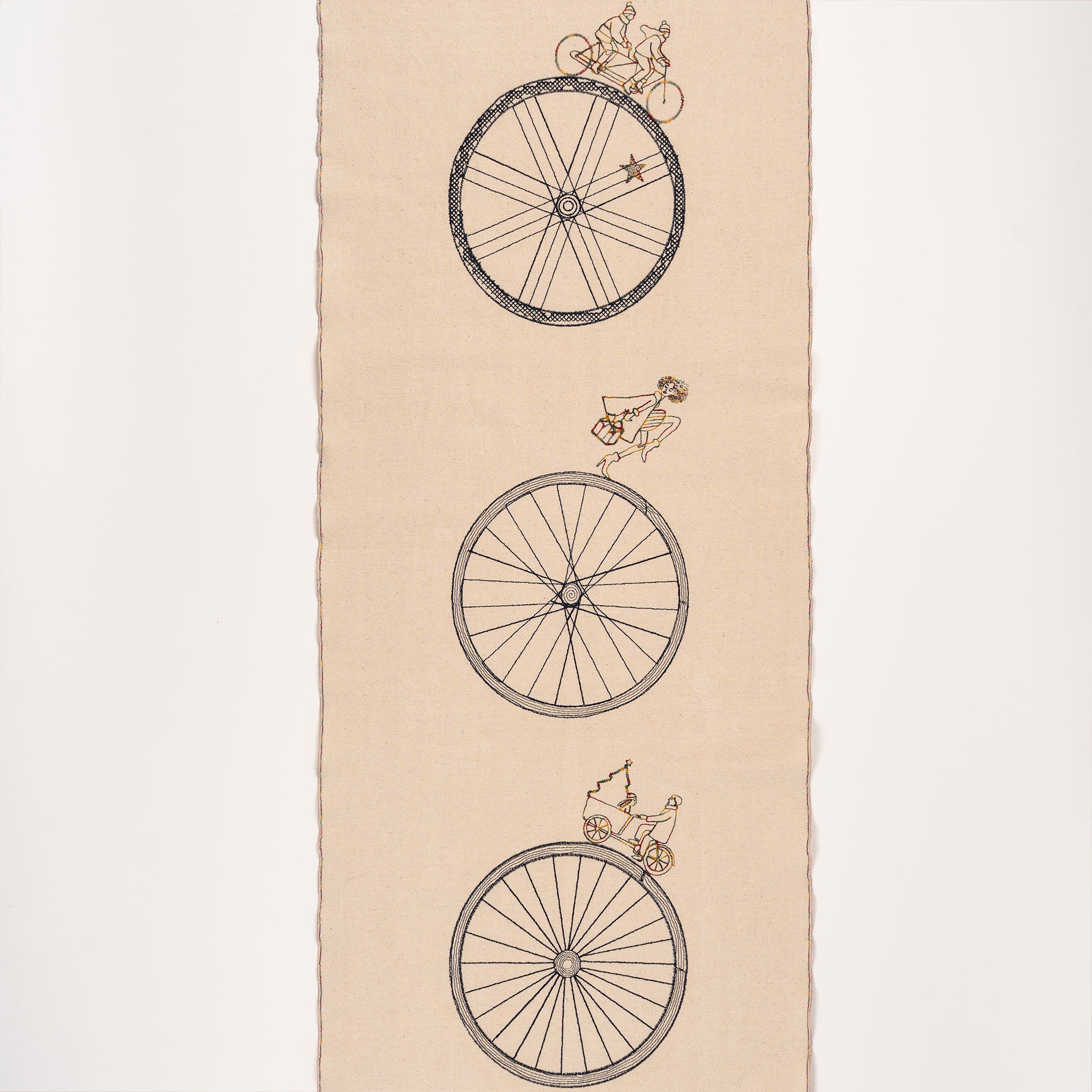 Handmade embroidered cotton table runner with bicycle motif, designed in the Netherlands for winter gatherings.

