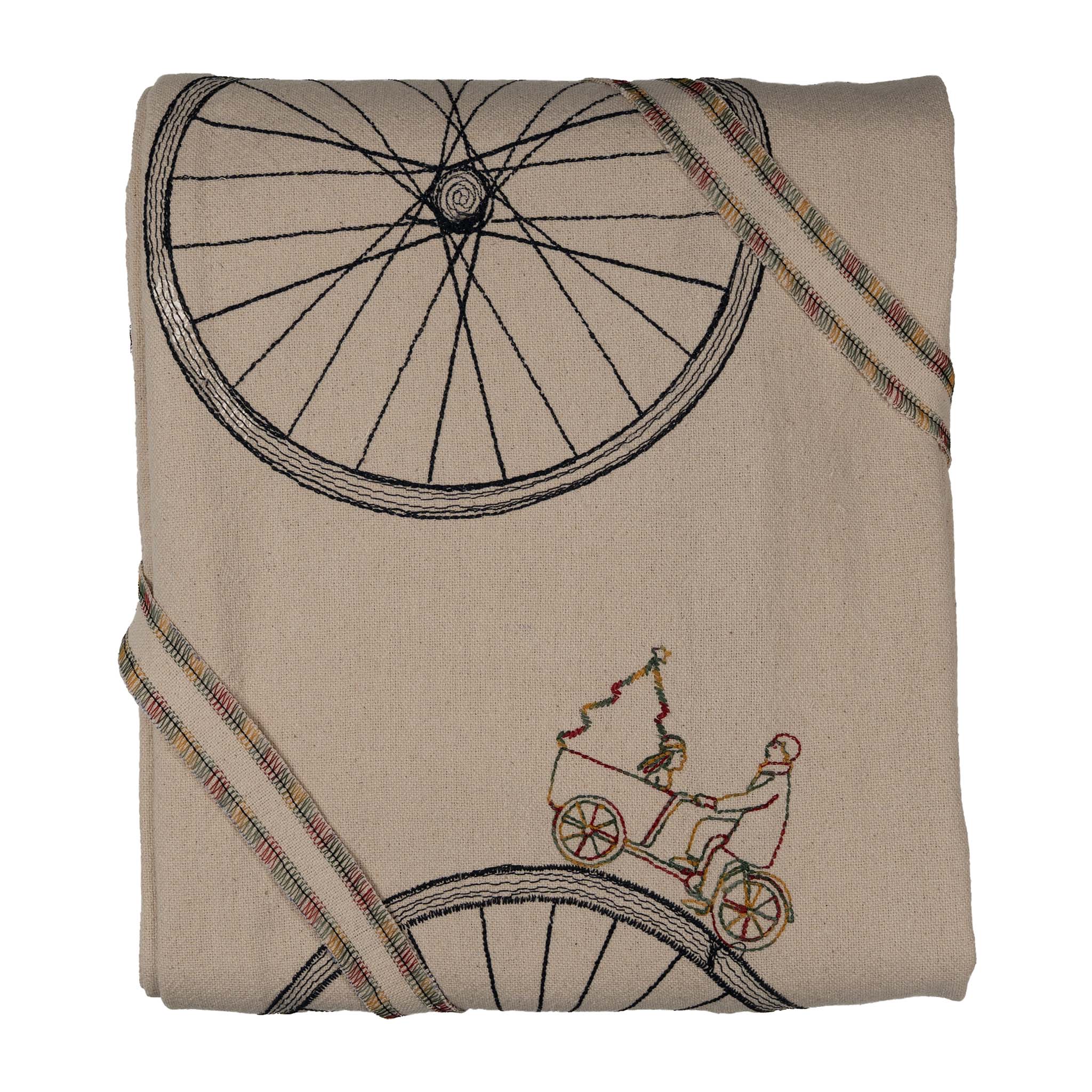 Large embroidered cotton tablecloth with bicycle motif, handmade in the Netherlands, celebrating movement and connection.
