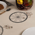 Load image into Gallery viewer, Large embroidered cotton tablecloth with bicycle motif, handmade in the Netherlands, celebrating movement and connection.

