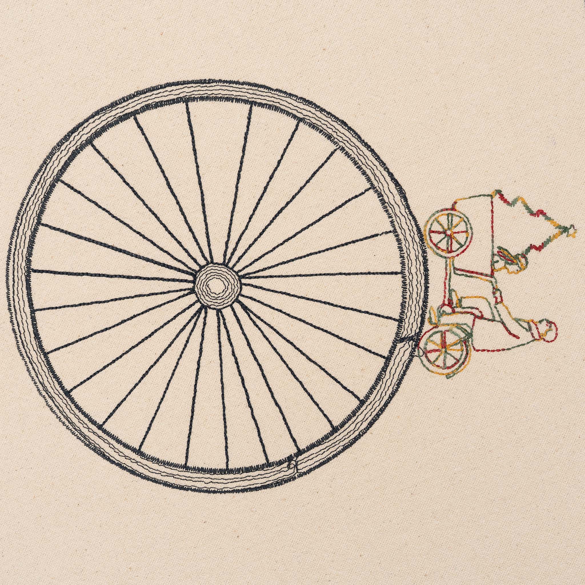 Large embroidered cotton tablecloth with bicycle motif, handmade in the Netherlands, celebrating movement and connection.
