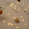 Load image into Gallery viewer, Handmade embroidered cotton tablecloth with festive light bulb design, crafted in the Netherlands for holiday gatherings.

