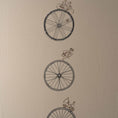 Load image into Gallery viewer, Large embroidered cotton tablecloth with bicycle motif, handmade in the Netherlands, celebrating movement and connection.

