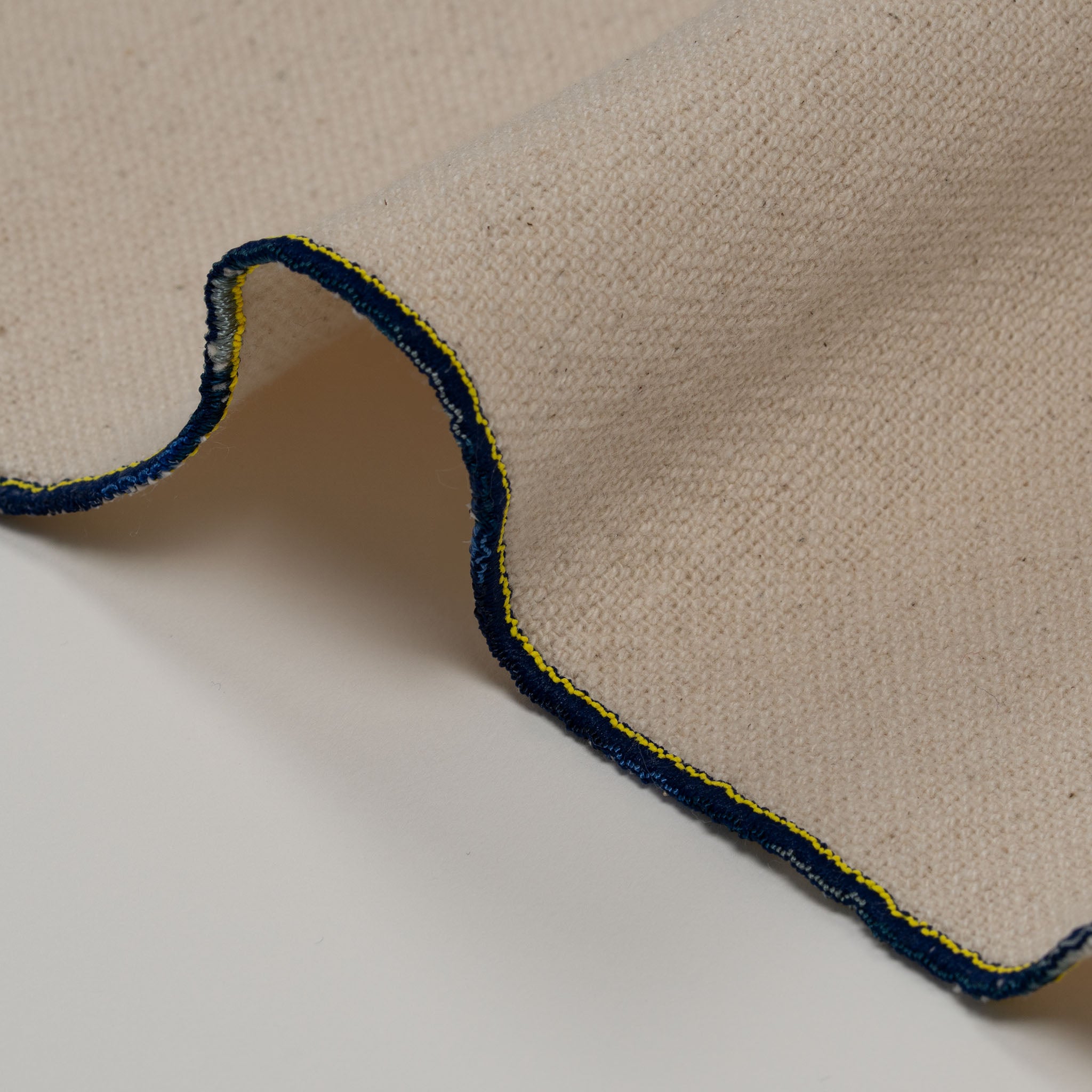 Embroidered cotton table runner featuring connected houses design, symbolizing home, family, and belonging.
