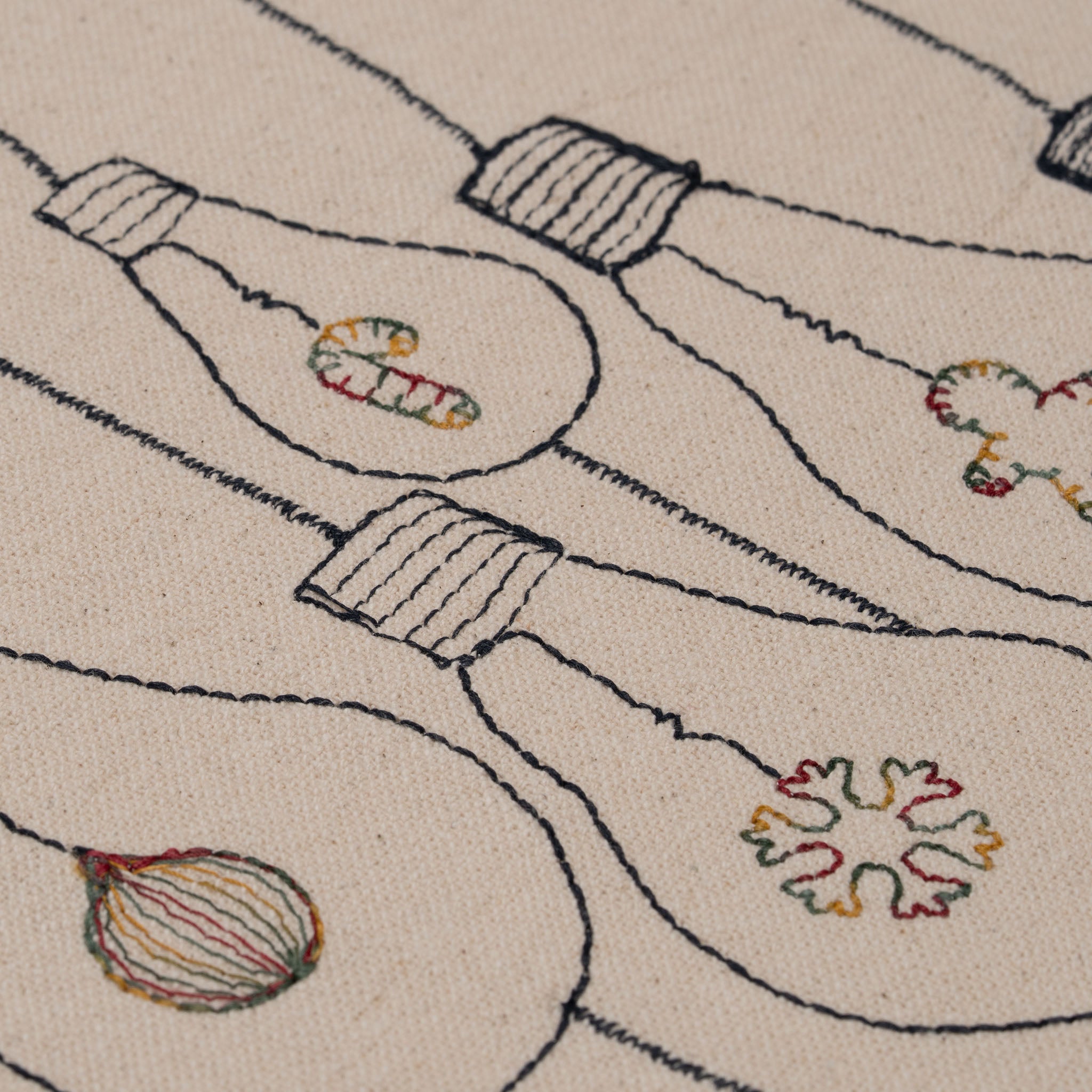 Handmade embroidered cotton tablecloth with festive light bulb design, crafted in the Netherlands for holiday gatherings.
