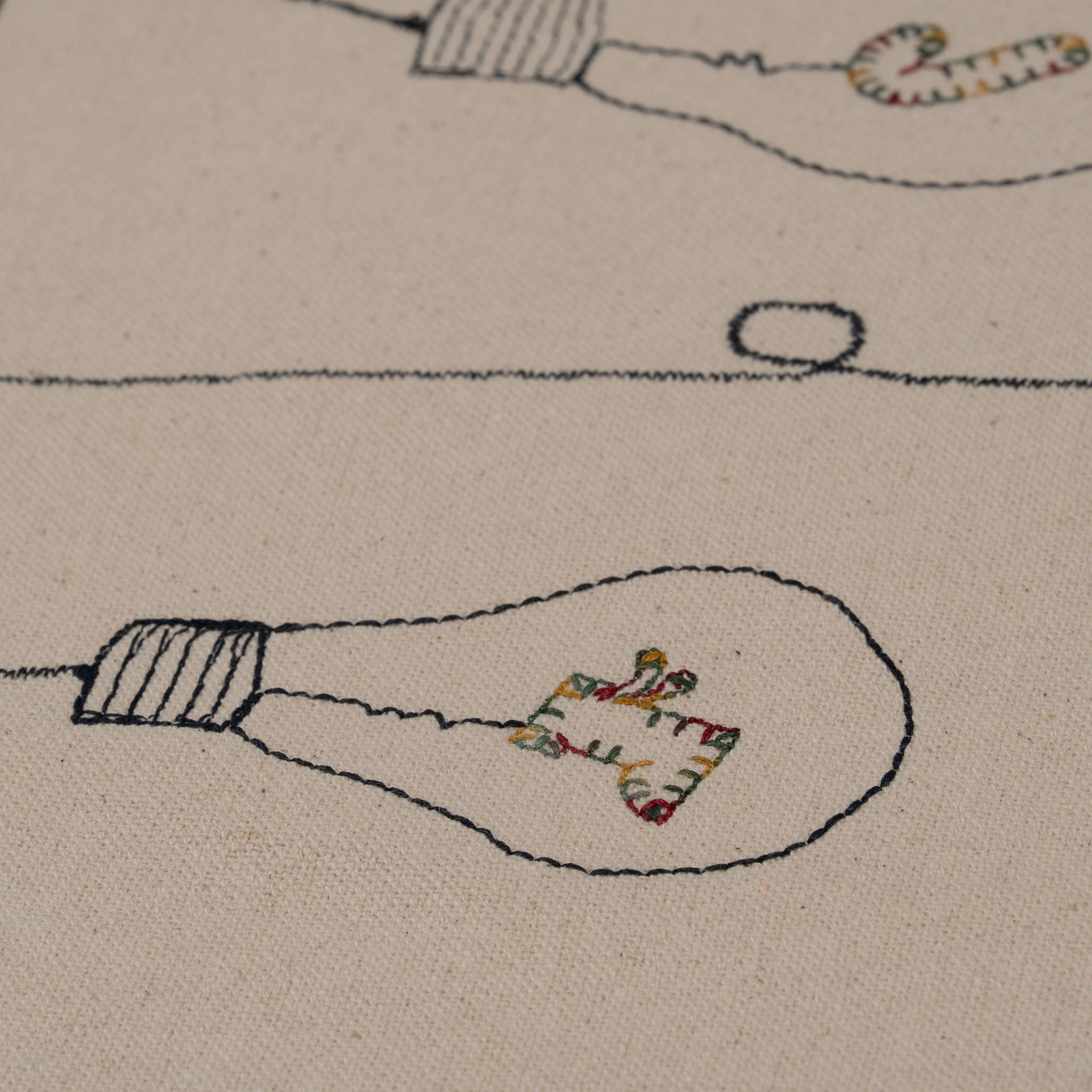 Handmade embroidered cotton tablecloth with festive light bulb design, crafted in the Netherlands for holiday gatherings.

