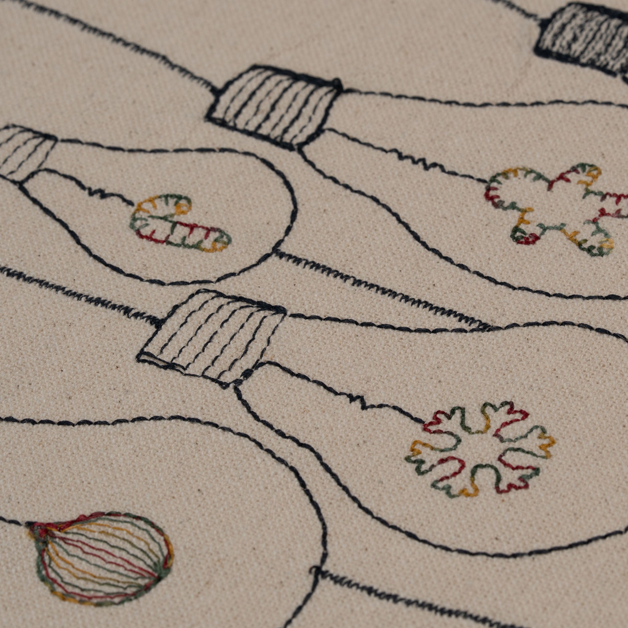 Handmade embroidered cotton tablecloth with festive light bulb design, crafted in the Netherlands for holiday gatherings.
