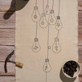 Bild in Galerie-Betrachter laden, Handcrafted embroidered cotton table runner with light bulb pattern, inspired by festive traditions and glowing memories.

