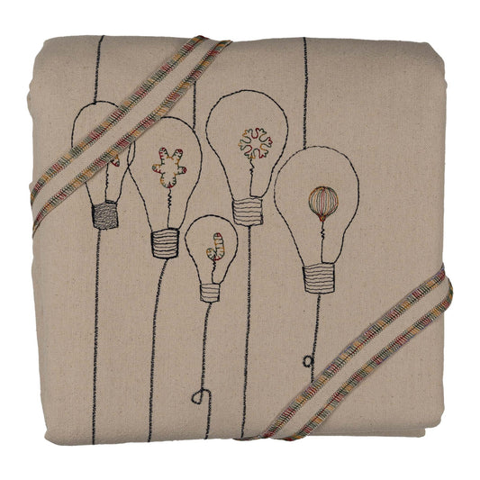 Handmade embroidered cotton tablecloth with festive light bulb design, crafted in the Netherlands for holiday gatherings.
