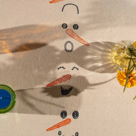 Winter-inspired embroidered cotton tablecloth with snowman motif, symbolizing childlike joy and family moments.
