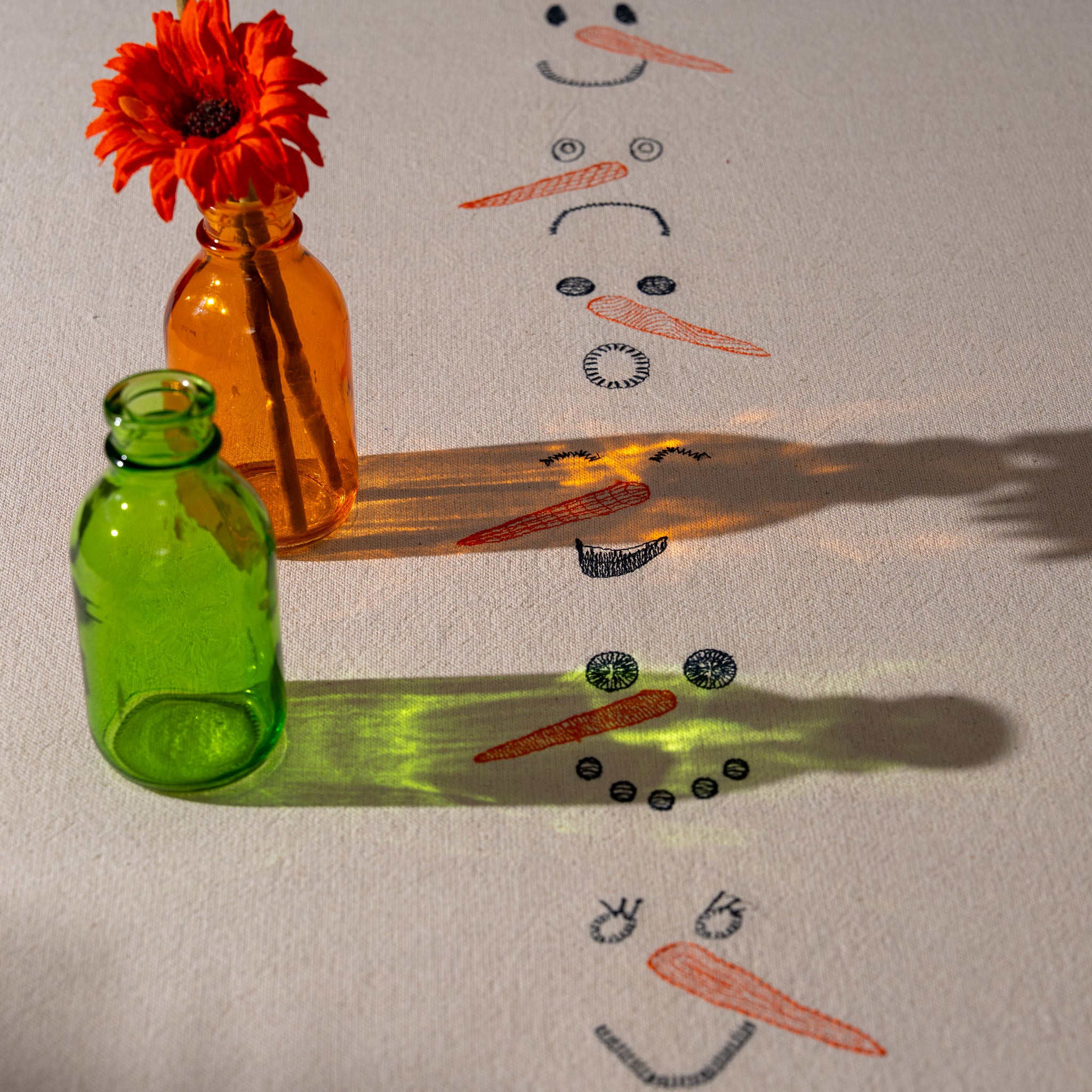 Winter-inspired embroidered cotton tablecloth with snowman motif, symbolizing childlike joy and family moments.
