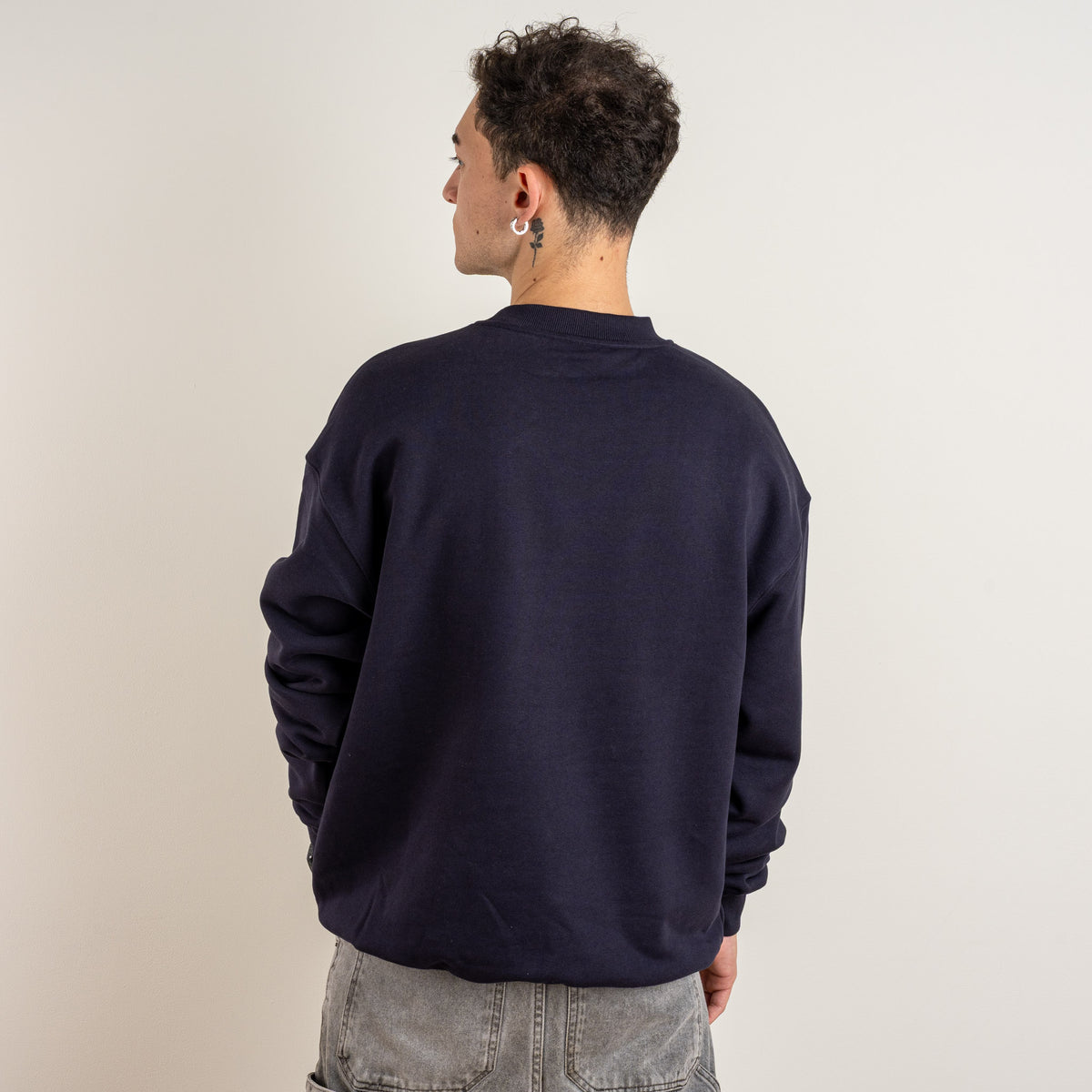 Back view of a model wearing the Gordina Garden and Water ink blue men's sweatshirt