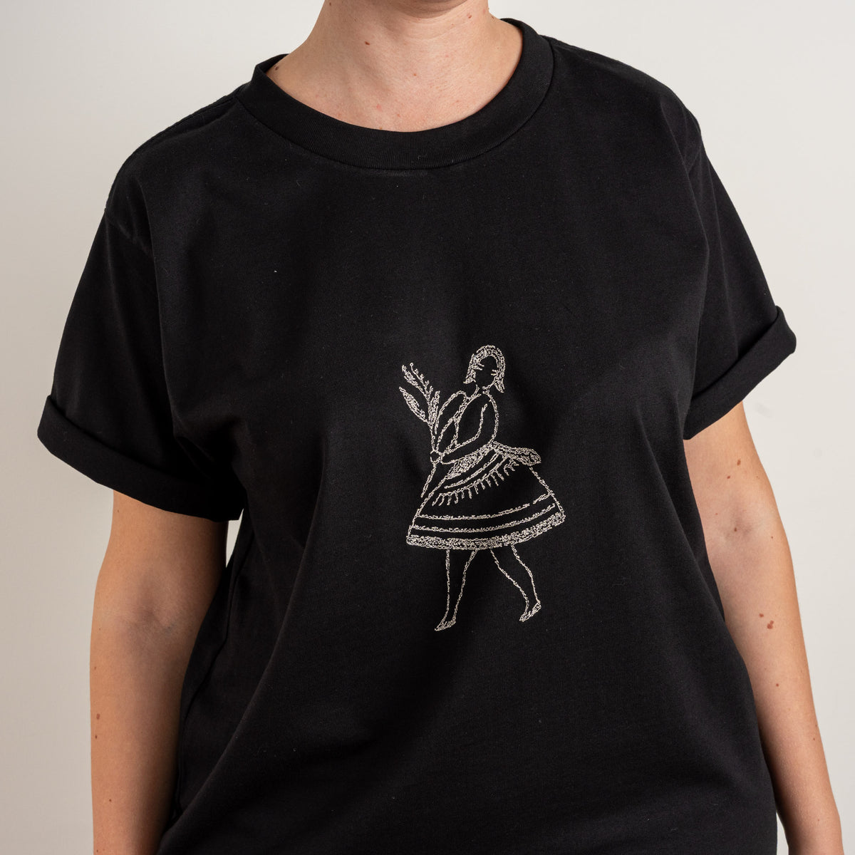 Detailed close-up of the dancer motif embroidered on Gordina's Black cotton T-shirt.