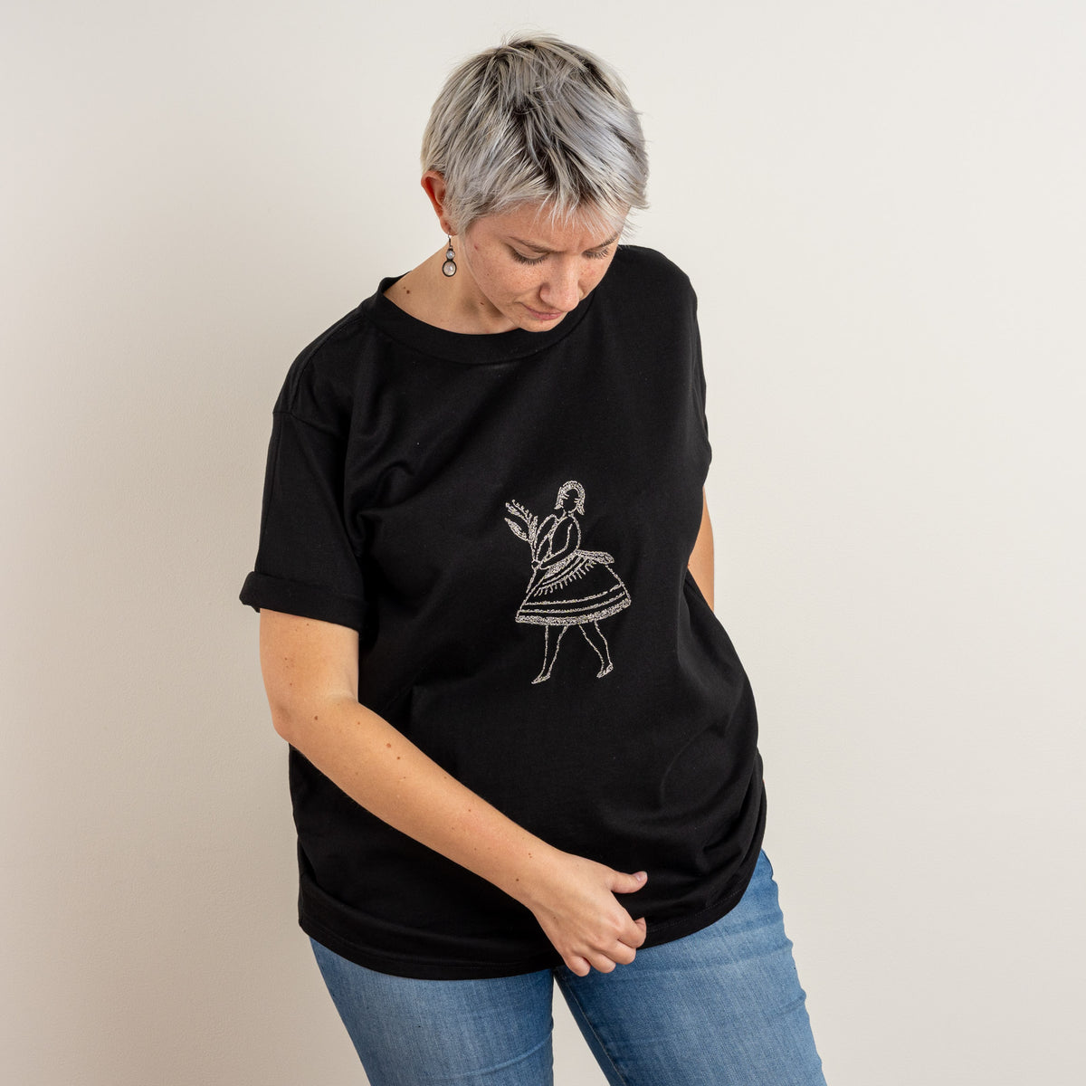 Woman wearing the Black La Bailarina embroidered T-shirt by Gordina in the Netherlands studio.