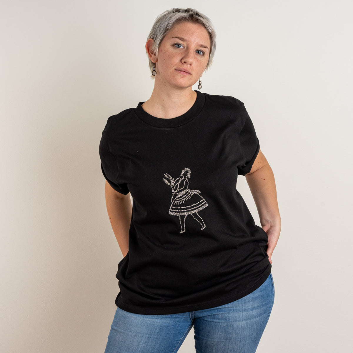 Front pose showing the cream dancing figure on Gordina's Black La Bailarina cotton T-shirt.