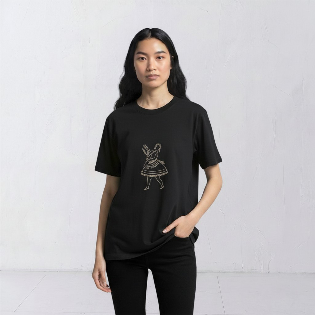 Model wearing the La Bailarina black T-shirt with a cream-thread dancing figure embroidered at the centre chest
