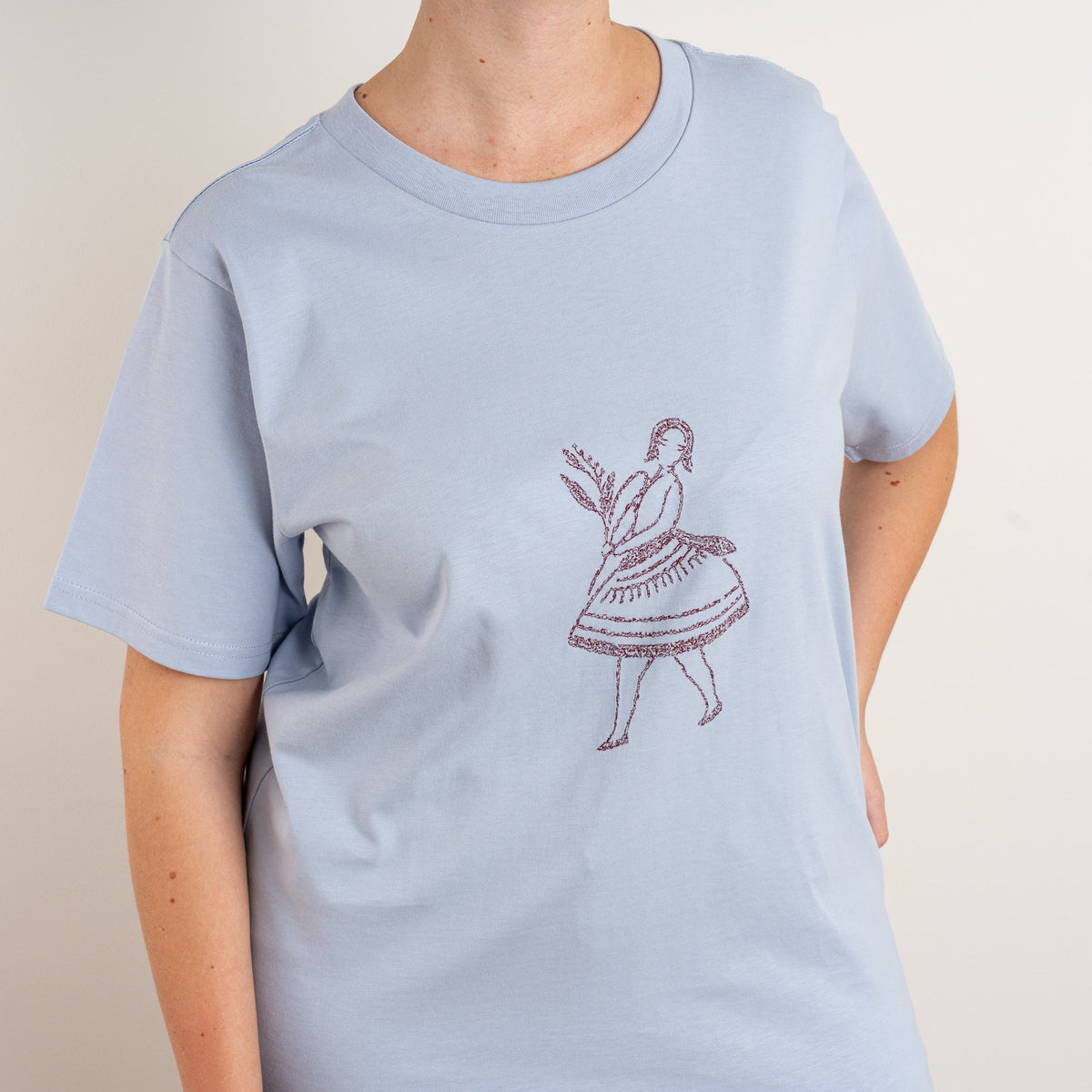 Close-up of the embroidered dancer motif on the front of the Powder La Bailarina cotton T-shirt for women.
