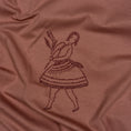 Load image into Gallery viewer, Close-up of dark-thread embroidery on the La Bailarina terracotta T-shirt, showing the dancer and flower branch
