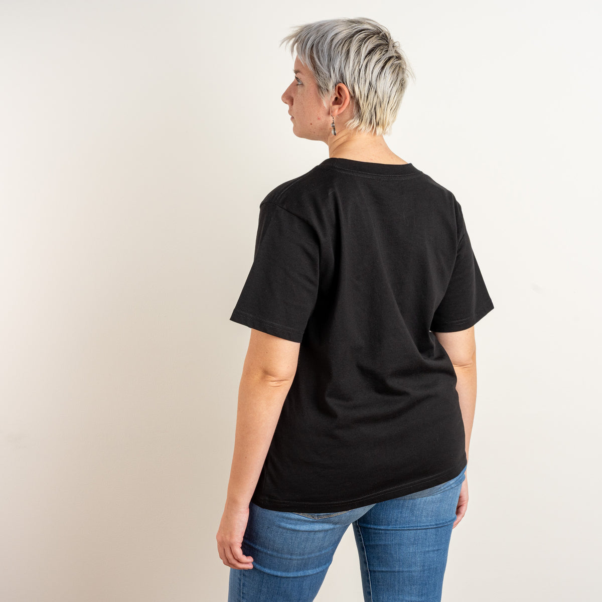 Back view of the women’s black Star and House T-shirt worn by a model.
