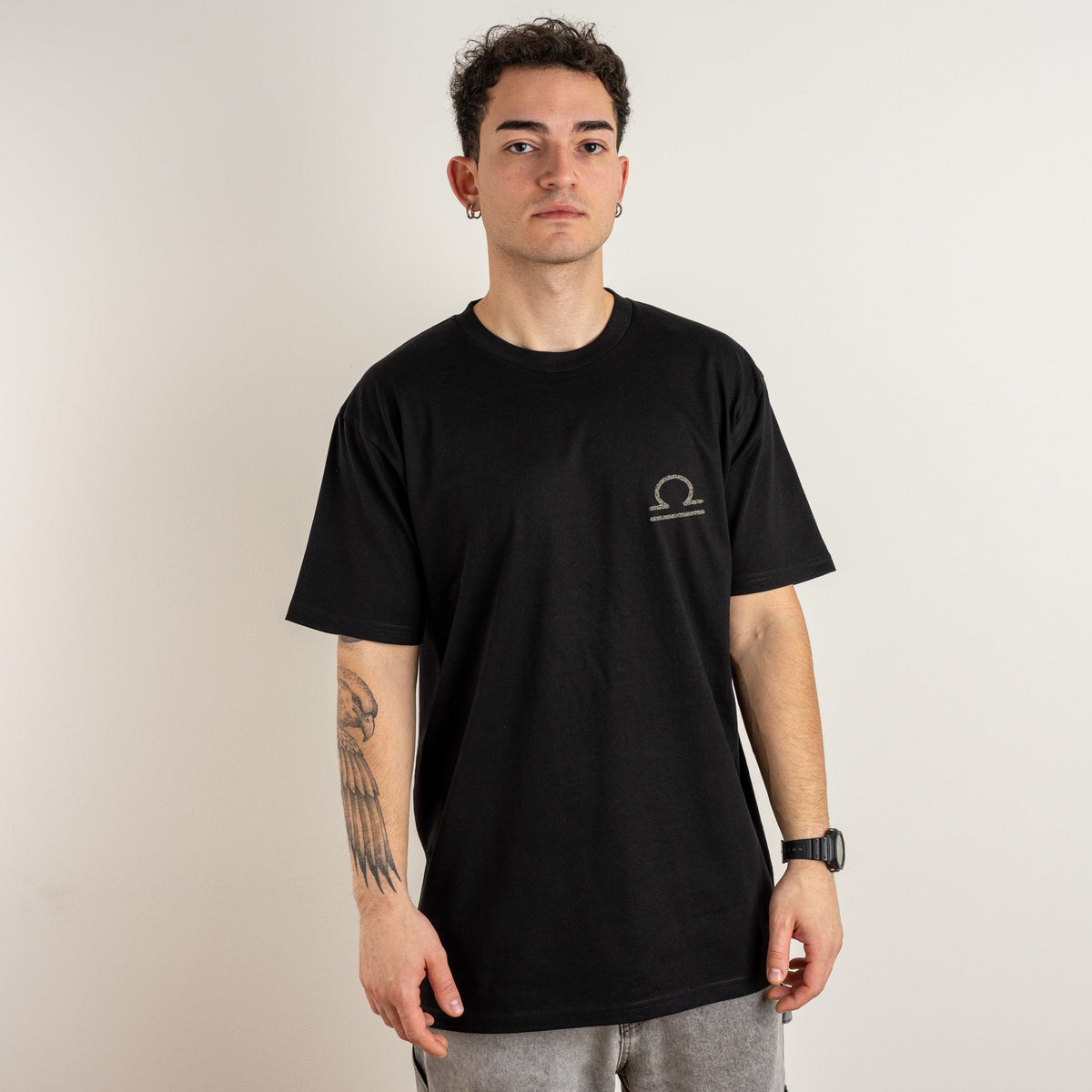 Man wearing the black personalised Classic Fit T-shirt with Libra embroidered on the left chest in ivory thread