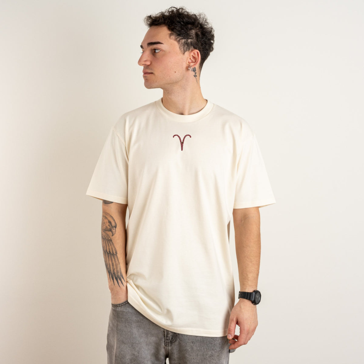 Man wearing the bone personalised Classic Fit T-shirt with Aries embroidered on the centre chest in crimson thread