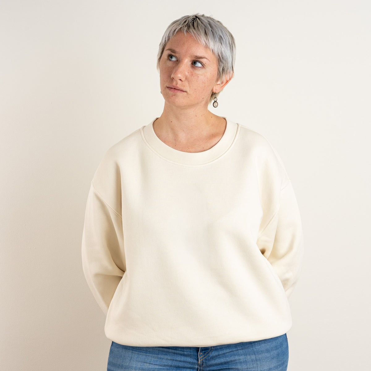 Woman wearing the bone personalised Women’s Relaxed Sweatshirt, front view