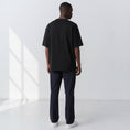Load image into Gallery viewer, Plain back view of a model wearing the Gordina black 5069 oversized cotton T-shirt.
