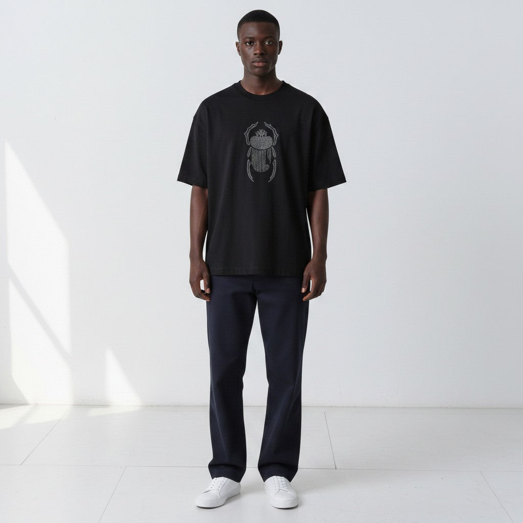 Closer front view of the Gordina The Scarab black oversized T-shirt with grey embroidery.