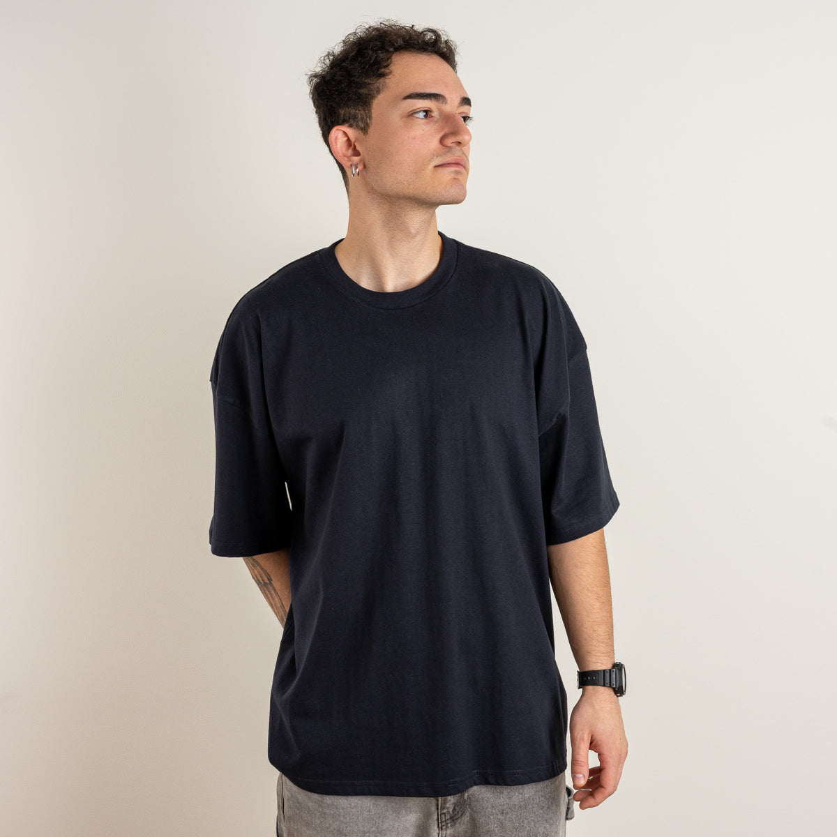 Three-quarter front view of the Gordina The Scarab navy oversized T-shirt, photographed for Gordina in the Netherlands.