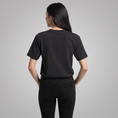 Load image into Gallery viewer, Star and House black T-shirt, model back view
