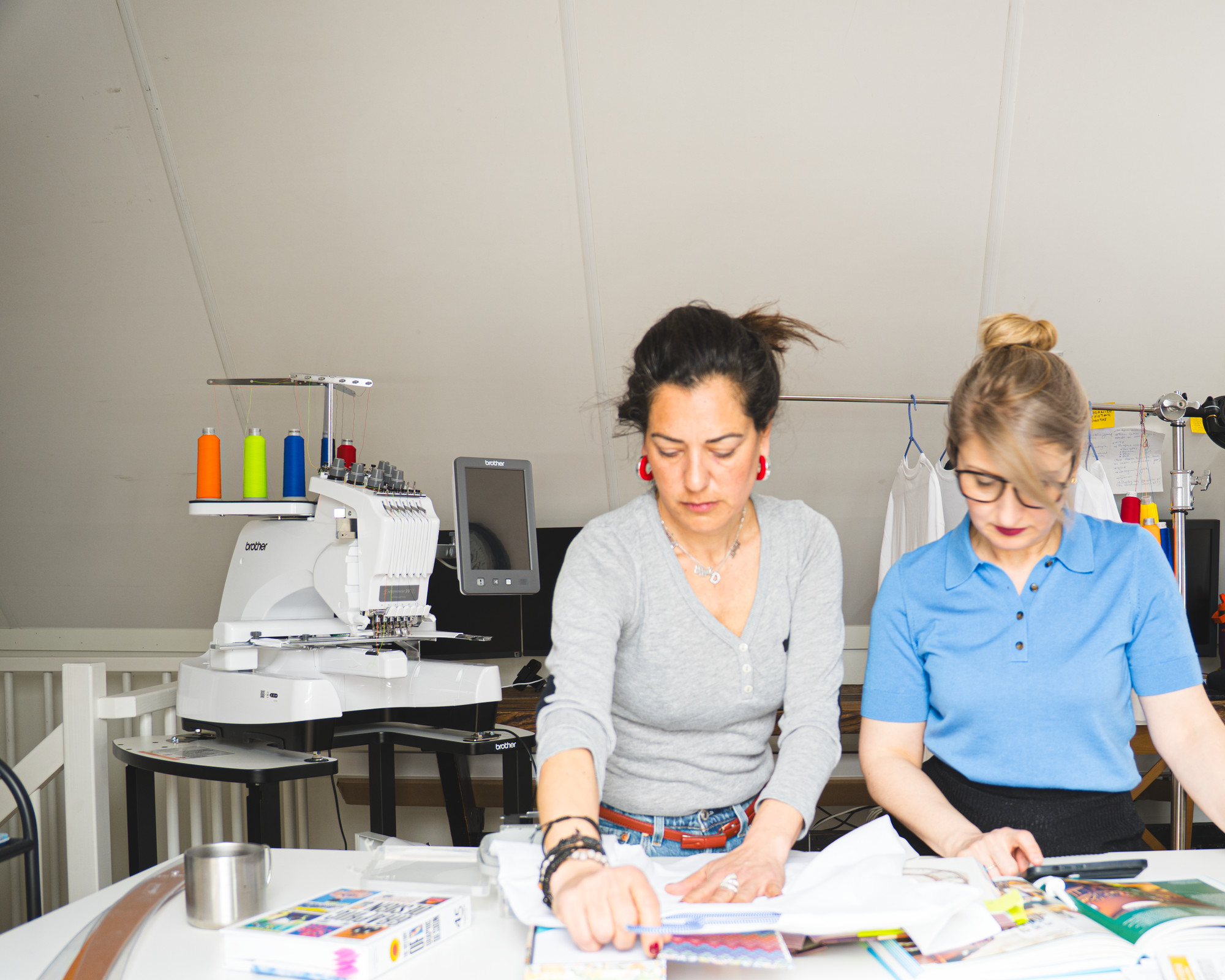 Embroidery studio process with two women designing textile products, Gordina sustainable embroidered t-shirt production