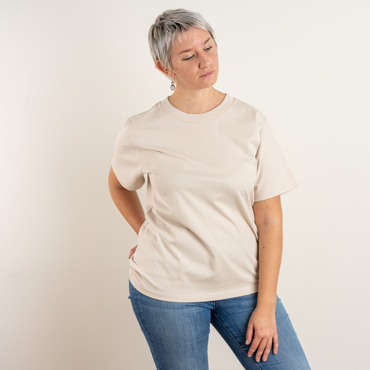 Woman wearing Gordina’s Bone Papyrus embroidered T-shirt, front view; embroidered in the Gordina studio in the Netherlands.