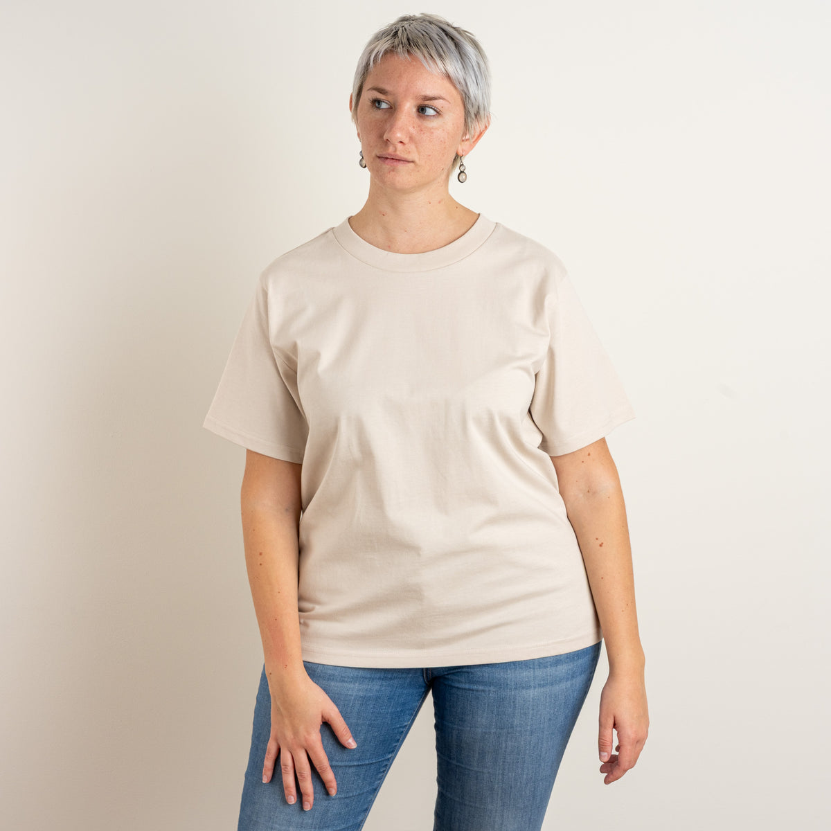 Front view of a woman wearing The Papyrus Bone women’s T-shirt by Gordina, embroidered in the Netherlands.