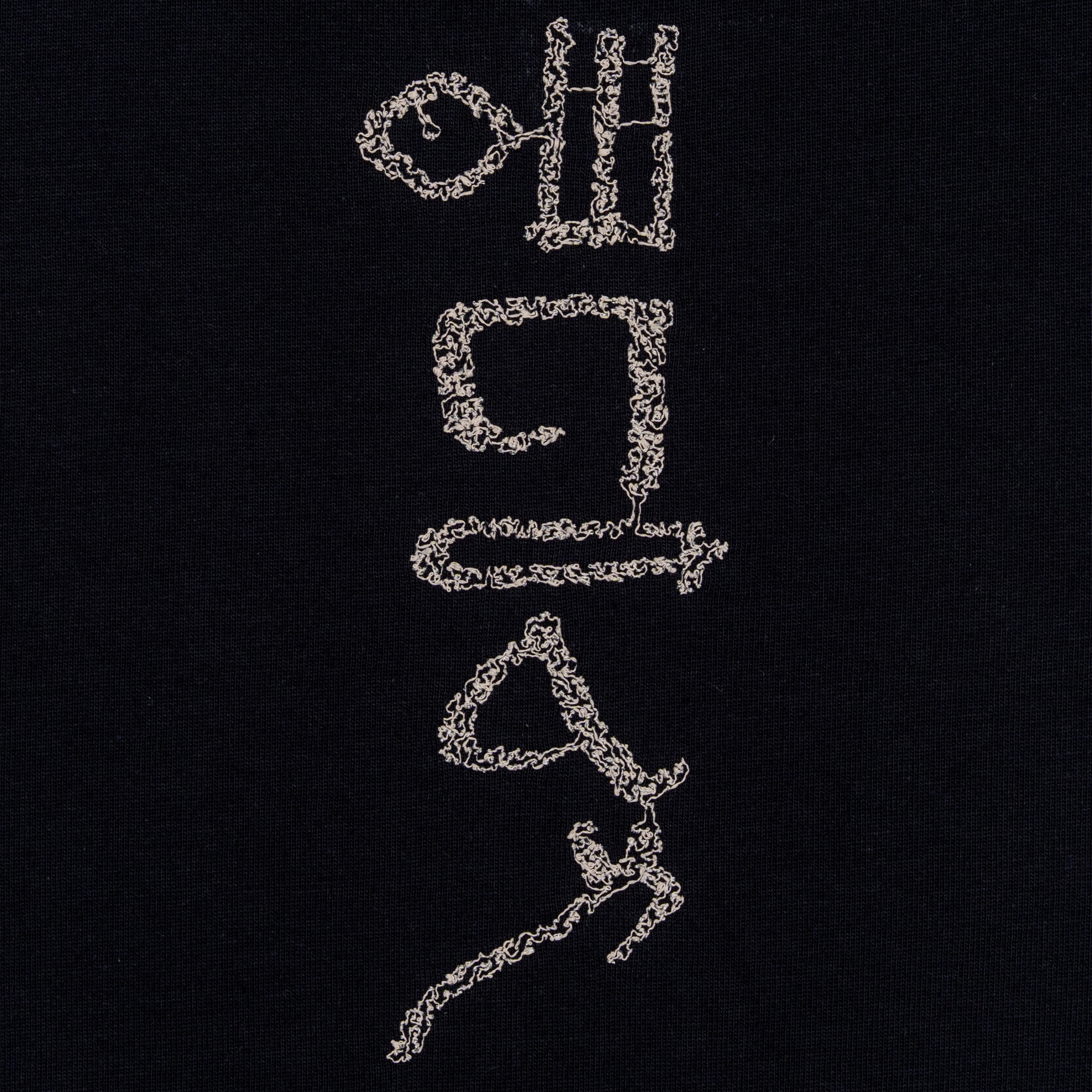 Close-up of the hieroglyphic-style embroidery on The Papyrus women’s navy T-shirt