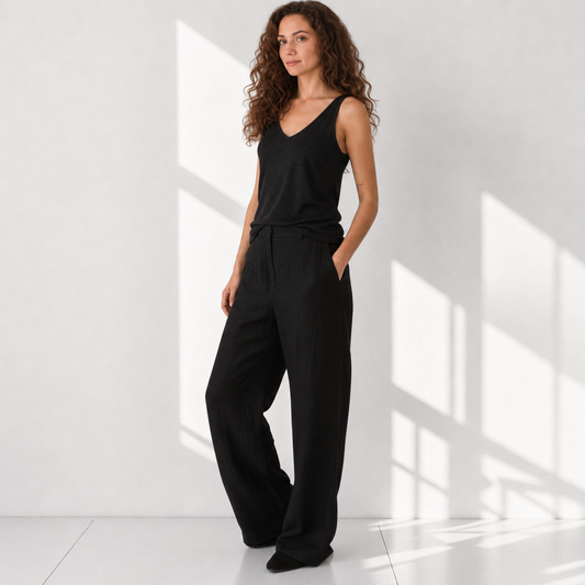The Poppy Black linen tank top with cream poppy embroidery, model front view