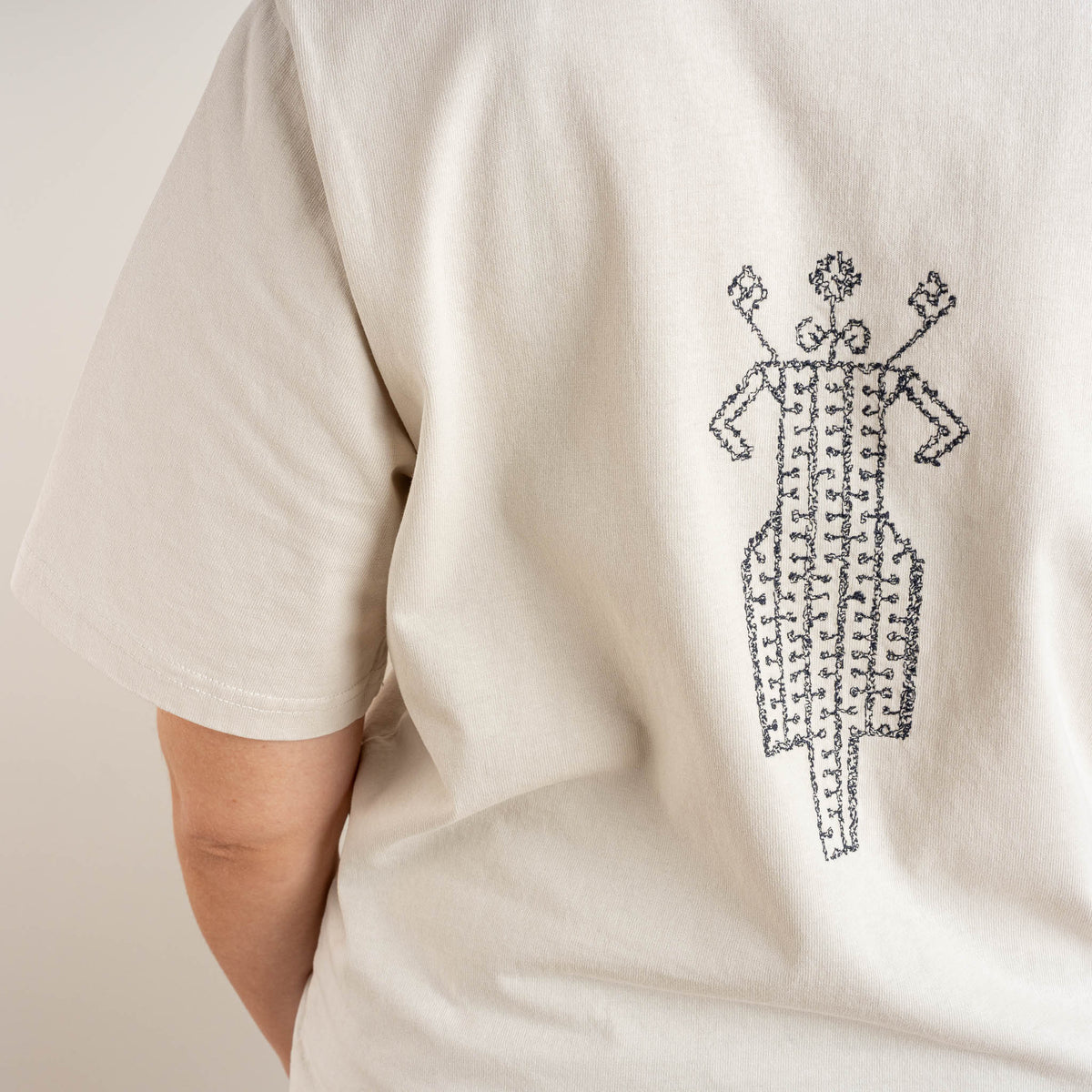 Close-up of the horse-and-rider embroidery stitched on The Ward Faded Bone cotton T-shirt by Gordina in the Netherlands.