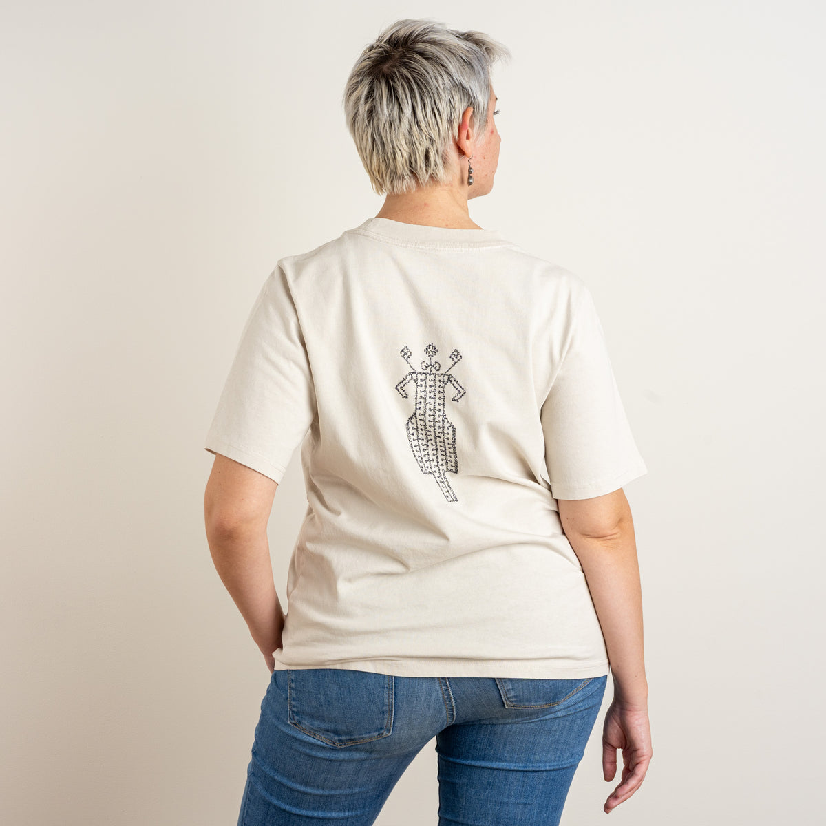 Back view of The Ward Faded Bone women's T-shirt with its folk-inspired embroidered motif.