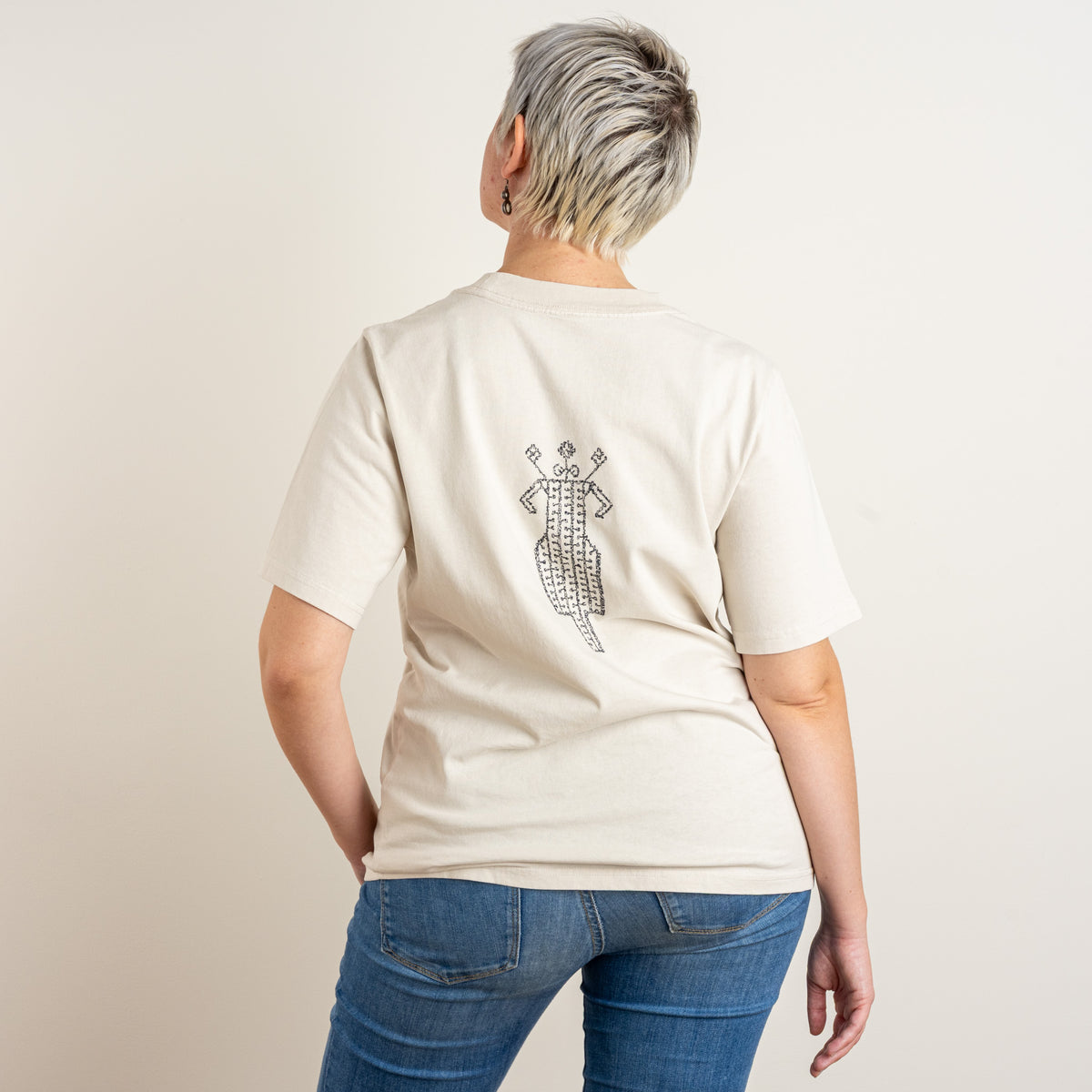 Full back view of The Ward Faded Bone women's embroidered cotton T-shirt, photographed in Nuenen, Netherlands.